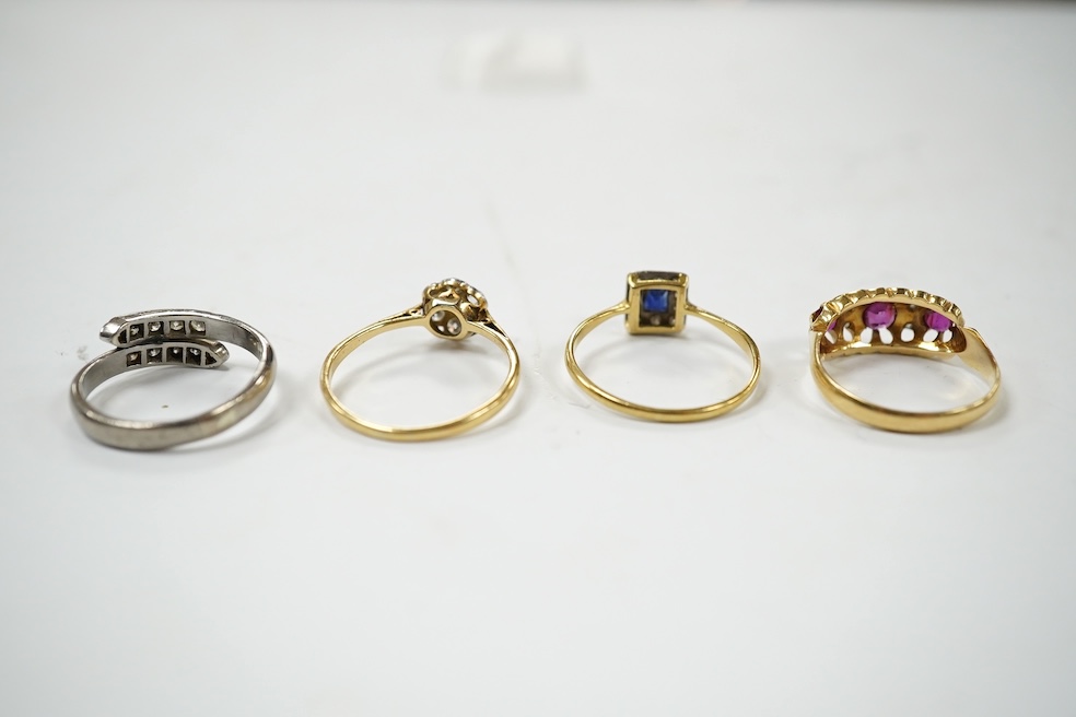 An 18ct and plat, sapphire and diamond set small cluster ring, size O, an 18ct and diamond set small cluster ring, an Edwardian 18ct gold, ruby and diamond set ring, a modern 18ct white gold and diamond set two row ring